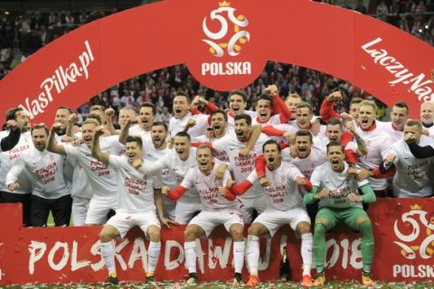 Polish national team players celebrate after they won their last World Cup Group E qualifying soccer match between Poland and Montenegro and qualified for the finals in Russia, at the National Stadium in Warsaw, Poland, Sunday, Oct. 8, 2017. (AP Photo/Alik Keplicz)