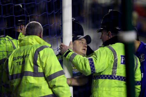 LIVERPOOL, ENGLAND - JANUARY 31:  Police speak to a man who handcuffed himself to the goal posts during the Barclays Premier League match between Everton and Manchester City at Goodison Park on January 31, 2012 in Liverpool, England.  (Photo by Alex Livesey/Getty Images)
