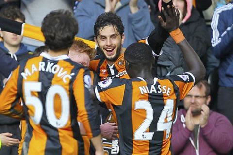 Hull City's Andrea Ranocchia celebrates scoring his side's second goal of the game with team mates,  during the English Premier League soccer match between Hull City and West Ham United, at the KCOM Stadium, in Hull, England, Saturday April 1, 2017.  (Richard Sellers/PA via AP)