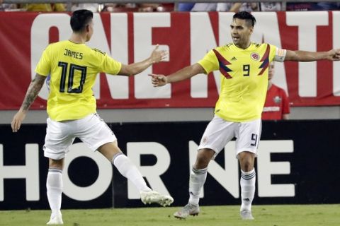 Colombia's Radamel Falcao (9) celebrates his goal against the United States with teammate James Rodriguez (10) during the second half of an international friendly soccer match Thursday, Oct. 11, 2018, in Tampa, Fla. (AP Photo/John Raoux)