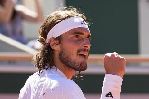 Stefanos Tsitsipas of Greece clenches his fist as he plays Serbia's Novak Djokovic during their final match of the French Open tennis tournament at the Roland Garros stadium Sunday, June 13, 2021 in Paris. (AP Photo/Michel Euler)