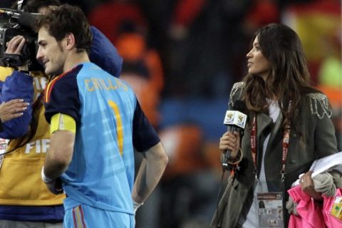 Spain goalkeeper Iker Casillas, left, walks away after an interview with Spanish TV journalist Sara Carbonero, right, at the end of the World Cup quarterfinal soccer match between Paraguay and Spain at Ellis Park Stadium in Johannesburg, South Africa, Saturday, July 3, 2010. Spain won 1-0. (AP Photo/Ivan Sekretarev)