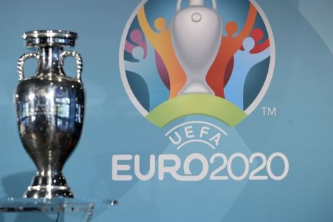 The Euro 2020 logo is pictured behind the trophy during the presentation of Munich's logo as one of the host cities of the Euro 2020 European soccer championships in Munich, Germany, Thursday, Oct. 27, 2016. (AP Photo/Matthias Schrader)