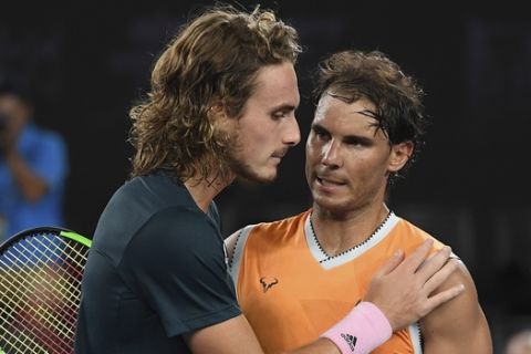 Spain's Rafael Nadal, right, is congratulated by Greece's Stefanos Tsitsipas after winning their semifinal at the Australian Open tennis championships in Melbourne, Australia, Thursday, Jan. 24, 2019.(AP Photo/Andy Brownbill)