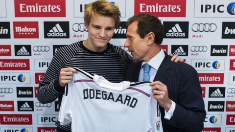 Norway international soccer player Martin Odegaard, left,  poses with Real Madrid's representative Emilio Butragueno, during his official presentation in Madrid, Spain, Thursday, Jan. 22, 2015, after signing for Real Madrid. (AP Photo/Andres Kudacki)