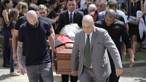 Nantes defender Nicolas Pallois, left, and family and friends of Argentina soccer player Emiliano Sala carry Sala's coffin during his funeral in Progreso, Argentina, Saturday, Feb. 16, 2019. The Argentina-born forward died in an airplane crash in the English Channel last month when flying from Nantes in France to start his new career with English Premier League club Cardiff. (AP Photo/Natacha Pisarenko)