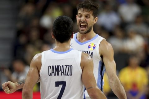 Argentina's Nicolas Laprovittola, at right celebrates with Argentina's Facundo Campazzo after defeating Serbia during a quarterfinal match for the FIBA Basketball World Cup in Dongguan in southern China's Guangdong province on Tuesday, Sept. 10, 2019. Argentina beats Serbia 97-87. (AP Photo/Ng Han Guan)