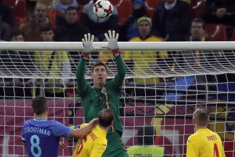 Romania's goalkeeper Costel Pantilimon, center, makes a save in front of Netherlands' Kevin Strootman, left, during the international friendly soccer match between Netherlands and Romania on the National Arena stadium in Bucharest, Romania, Tuesday, Nov. 14, 2017. (AP Photo/Vadim Ghirda)