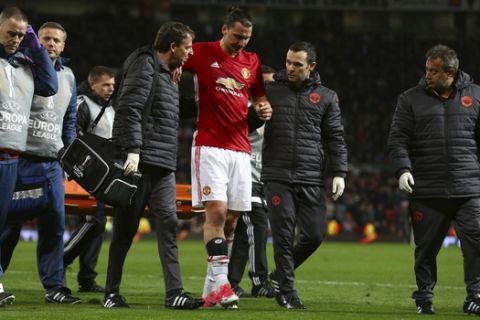 Manchester United's Zlatan Ibrahimovic, center, leaves the field with an injury during the Europa League quarterfinal second leg soccer match between Manchester United and Anderlecht at Old Trafford stadium, in Manchester, England, Thursday, April 20, 2017. (AP Photo/Dave Thompson)