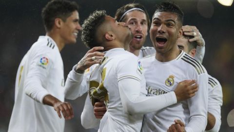 Real Madrid's Mariano Diaz, center left, celebrates with teammates after scoring his side's second goal during the Spanish La Liga soccer match between Real Madrid and Barcelona at the Santiago Bernabeu stadium in Madrid, Spain, Sunday, March 1, 2020. (AP Photo/Manu Fernandez)