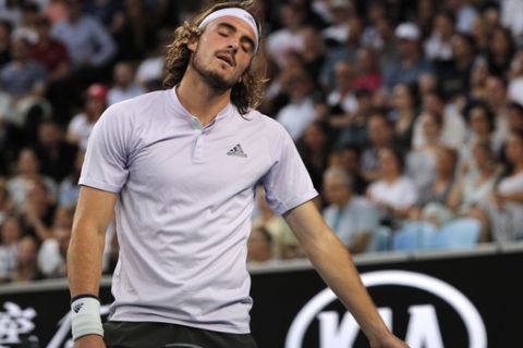 Greece's Stefanos Tsitsipas reacts during his third round singles match against Canada's Milos Raonic at the Australian Open tennis championship in Melbourne, Australia, Friday, Jan. 24, 2020. (AP Photo/Andy Wong)