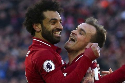 Liverpool's Xherdan Shaqiri , right, celebrates scoring his side's third goal of the game with Mohamed Salah, during the English Premier League soccer match between Liverpool and Cardiff City at Anfield, in Liverpool, England, Saturday, Oct. 27, 2018. (Dave Thompson/PA via AP)
