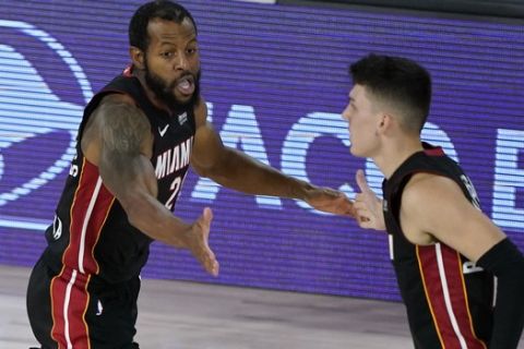 Miami Heat's Andre Iguodala, left, celebrates with Miami Heat's Tyler Herro during the second half of an NBA basketball first round playoff game against the Indiana Pacers, Monday, Aug. 24, 2020, in Lake Buena Vista, Fla. (AP Photo/Ashley Landis, Pool)