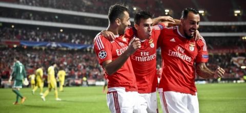 Benfica's Argentinian midfielder Nico Gaitan (C) celebrates a goal with teammate Brazilian forward Jonas Oliveira (L) and Greek forward Konstantinos Mitroglou (R) during the UEFA Champions League football match SL Benfica vs FC Astana at the Luz stadium in Lisbon on September 15, 2015. AFP PHOTO / FRANCISCO LEONG        (Photo credit should read FRANCISCO LEONG/AFP/Getty Images)