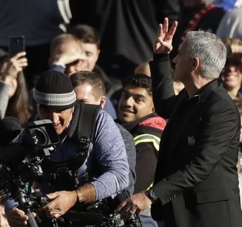 ManU coach Jose Mourinho flashes three fingers after the English Premier League soccer match between Chelsea and Manchester United at Stamford Bridge stadium in London Saturday, Oct. 20, 2018. (AP Photo/Matt Dunham)