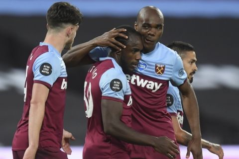 West Ham's Michail Antonio, second left is congatulated by teammate West Ham's Angelo Ogbonna after scoring his sides second goal of the game during the English Premier League soccer match between West Ham United and Chelsea at the London Stadium stadium in London, Wednesday July 1, 2020. (Michael Regan/Pool via AP)