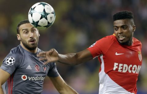 Besiktas' Cenk Tosun, left, challenges for the ball with Monaco's Jemerson during the Champions League Group G first leg soccer match between Monaco and Besiktas at Louis II stadium in Monaco, Tuesday, Oct. 17, 2017. (AP Photo/Claude Paris)