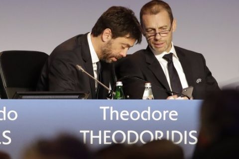 UEFA President Aleksander Ceferin, right, listens to Juventus President Andrea Agnelli during a pause of the 43rd UEFA congress in Rome, Thursday, Feb. 7, 2019. Promising European soccer leaders that he won't be a "yes man" for FIFA's expansion plans, Aleksander Ceferin was re-elected as president of UEFA for four more years on Thursday. (AP Photo/Alessandra Tarantino)