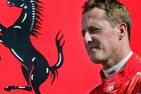 Germany's Michael Schumacher walks through the pit area before a test session in his Ferrari Formula One motor racing car at the Jerez racetrack, in Jerez, southern Spain, Wednesday, Oct. 11, 2006. (AP Photo/Javier Barbancho)