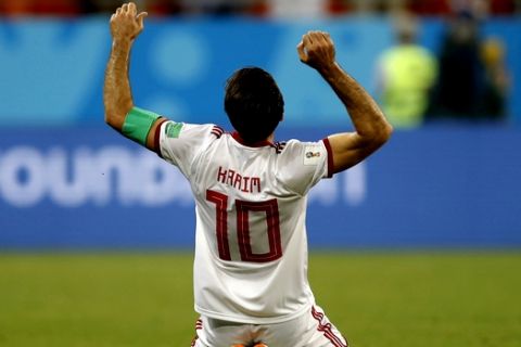 Iran's Karim Ansarifard celebrates after scoring his sides 1st gaol from the penalty spot during the group B match between Iran and Portugal at the 2018 soccer World Cup at the Mordovia Arena in Saransk, Russia, Monday, June 25, 2018. (AP Photo/Francisco Seco)