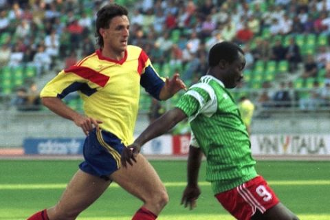 FILE - The June 14, 1990 file photo shows Cameroon's Roger Milla, right, being] about to score the first of his two goals against Romania, as Romanian defender Gheorghe Popescu tries to stop him, during the World Cup soccer match in Bari, Italy. This was to be Africa's World Cup, not just the first to take place on the continent but also a chance for its teams to excel. Mostly, however, it's been another letdown, and the post-mortems have begun.  Explanations abound _ and several have the ring of truth: weak youth development programs, lack of depth on the national teams, overreliance on non-African coaches hired for brief World Cup tenures, national governing bodies that lack world-class professionalism. The bottom line: Africa's six World Cup teams _ the most ever in the tournament _ produced flashes of brilliance and feistiness,  but collectively failed to close the gap with Europe and South America.    (AP Photo/Giulio Broglio)