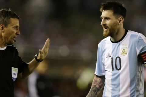 In this photo taken Thursday March 23, 2017 Argentina's Lionel Messi argues assistant referee Emerson Augusto de Carvalho during a World Cup qualifying match against Chile in Buenos Aires, Argentina. Messi has been banned from Argentina's next four World Cup qualifiers, starting with Tuesday's game in Bolivia, for "having directed insulting words at an assistant referee" during a home qualifier against Chile on Thursday, FIFA said hours before kickoff in La Paz.(AP Photo/Victor R. Caivano)