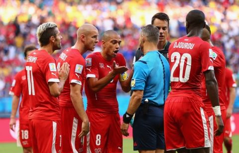 SALVADOR, BRAZIL - JUNE 20:  Switzerland protest a penalty being awarded by referee Bjorn Kuipers during the 2014 FIFA World Cup Brazil Group E match between Switzerland and France at Arena Fonte Nova on June 20, 2014 in Salvador, Brazil.  (Photo by Elsa/Getty Images)