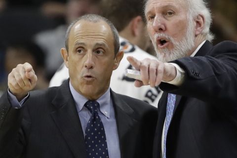 San Antonio Spurs coach Gregg Popovich, right, and assistant Ettore Messina, left, talk during the second half of the team's NBA basketball game against the Washington Wizards, Friday, Dec. 2, 2016, in San Antonio. San Antonio won 107-105. (AP Photo/Eric Gay)