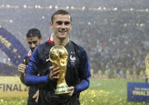 France's Antoine Griezmann celebrates with the trophy after the final match between France and Croatia at the 2018 soccer World Cup in the Luzhniki Stadium in Moscow, Russia, Sunday, July 15, 2018. France won the final 4-2. (AP Photo/Matthias Schrader)