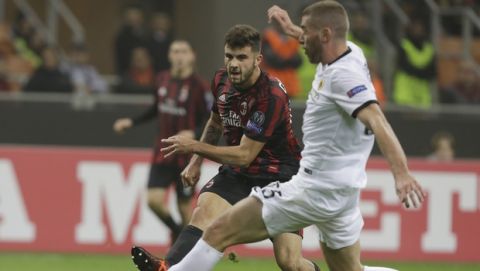 AC Milan's Patrick Cutrone and Athen's Adam Tzanetopoulos vie for the ball during an Europa League, Group D, soccer match between AC Milan and AEK Athens, at the San Siro stadium in Milan, Italy, Thursday, Oct. 19, 2017. (AP Photo/Luca Bruno)