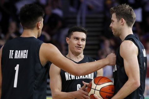 From left, Reuben Te Rangi, Jarrod Kenny, and Thomas Abercrombie of New Zealand celebrate after beating Scotland in their bronze medal men's basketball game at the Gold Coast Convention and Exhibition Centre during the 2018 Commonwealth Games on the Gold Coast, Australia, Sunday, April 15, 2018. (AP Photo/Mark Schiefelbein)