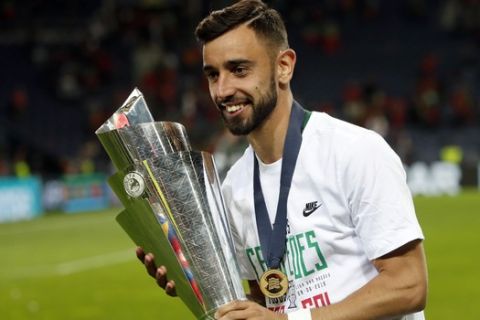 FILE - In this June 9, 2019, file photo, Portugal's Bruno Fernandes poses with the trophy at the end of the UEFA Nations League final soccer match between Portugal and Netherlands at the Dragao stadium in Porto, Portugal.  According to news reports Wednesday, Jan. 29, 2020, Lisbon's Sporting CP midfielder Fernandes is expected to join Manchester United following months of negotiations between the two clubs. (AP Photo/Armando Franca, FILE)