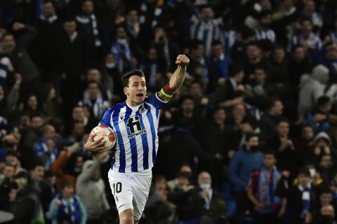 Real Sociedad's Mikel Oyarzabal celebrates after his teammate Real Sociedad's Martin Zubimendi scores his side's opening goal during the Europa League Play-off, second leg, soccer match between Real Sociedad and Leipzig at the Reale Arena stadium in San Sebastian, Spain, Thursday, Feb. 24, 2022. (AP Photo/Alvaro Barrientos)