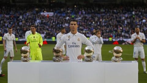 Real Madrid's Cristiano Ronaldo poses for the media with his four golden balls prior the Spanish La Liga soccer match between Real Madrid and Granada at the Santiago Bernabeu stadium in Madrid, Saturday, Jan. 7, 2017. (AP Photo/Francisco Seco)