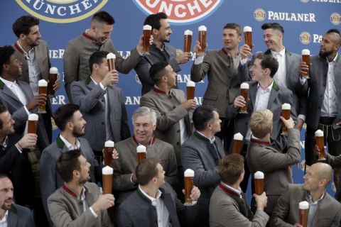 Bayern's players salut to team mate Thomas Mueller, last row 3rd right, in traditional Bavarian clothes during a photo-shooting of a beer brewing company in Munich, Germany, Wednesday, Sept. 13, 2017. Mueller celebrates his 28th birthday today. (AP Photo/Matthias Schrader)