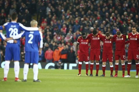 Porto, left, and Liverpool players stand, during a minute of silence for Fiorentina player Davide Astori who died Sunday, before the Champions League round of 16, second leg, soccer match between Liverpool and FC Porto at Anfield Stadium, Liverpool, England, Tuesday March 6, 2018. (AP Photo/Dave Thompson)