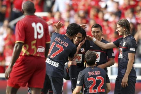 Radamel Falcao (C) of Spain's Atletico Madrid celebrates with team mates after scoring against Colombia's America de Cali during their friendly soccer match in Cali May 19, 2012.  REUTERS/Stringer  (COLOMBIA - Tags: SPORT SOCCER)