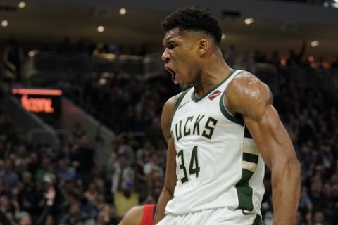 Milwaukee Bucks' Giannis Antetokounmpo reacts after a dunk during the second half of an NBA basketball game against the New Orleans Pelicans Wednesday, Dec. 19, 2018, in Milwaukee. The Bucks won 123-115. (AP Photo/Morry Gash)