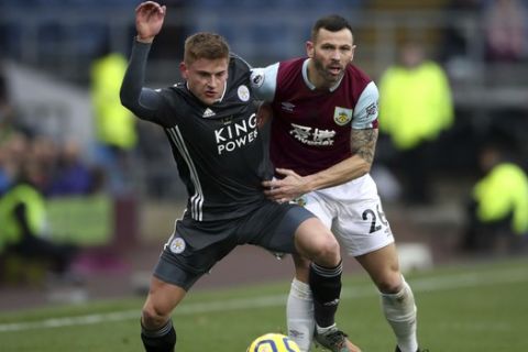 Leicester City's Harvey Barnes, left, and Burnley's Phil Bardsley in action during their English Premier League soccer match at Turf Moor in Burnley, England, Sunday Jan. 19, 2020. (Nick Potts/PA via AP)