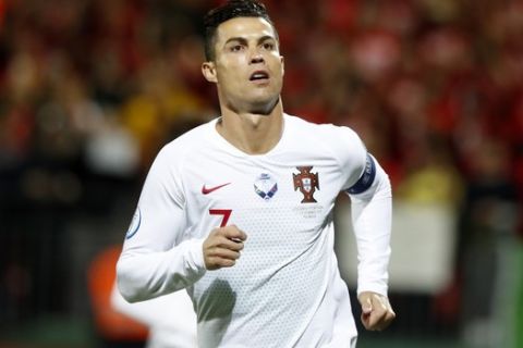 Portugal's Cristiano Ronaldo celebrates after scoring his side's opening goal from a penalty shot during the Euro 2020 group B qualifying soccer match between Lithuania and Portugal at LFF stadium in Vilnius, Lithuania, Tuesday, Sept. 10, 2019. (AP Photo/Mindaugas Kulbis)