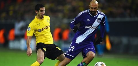 DORTMUND, GERMANY - DECEMBER 09: Anthony Vanden Borre of Anderlecht is closed down by Henrikh Mkhitaryan of Borussia Dortmund during the UEFA Champions League Group D match between Borussia Dortmund and RSC Anderlecht at Signal Iduna Park on December 9, 2014 in Dortmund, Germany.  (Photo by Dennis Grombkowski/Bongarts/Getty Images)