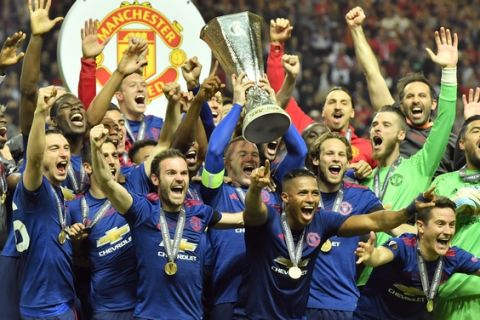 United's Wayne Rooney, center, lifts the trophy after winning the soccer Europa League final between Ajax Amsterdam and Manchester United at the Friends Arena in Stockholm, Sweden, Wednesday, May 24, 2017. United won 2-0. (AP Photo/Martin Meissner)