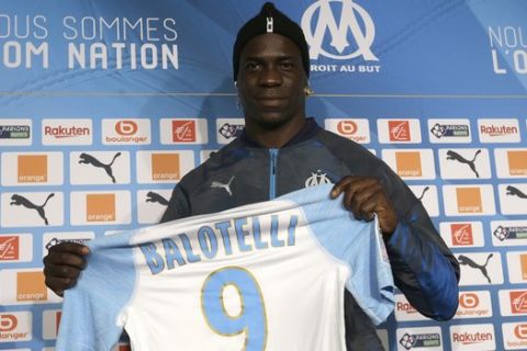 Olympique Marseille's new player Mario Balotelli poses with his new jersey during a press conference, at the club's headquarters of La Commanderie, in Marseille, southern France , Wednesday, Jan. 23, 2019. (AP Photo/Claude Paris)