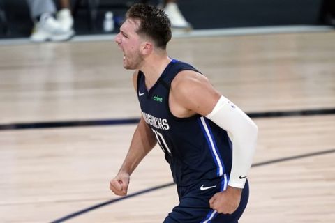 Dallas Mavericks' Luka Doncic (77) reacts after making a basket against the Los Angeles Clippers during the second half of an NBA basketball first round playoff game Sunday, Aug. 23, 2020, in Lake Buena Vista, Fla. (AP Photo/Ashley Landis, Pool)