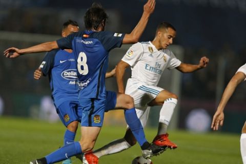 Real Madrid's Lucas Vazquez, right, tussles for the ball with Fuenlabrada's Miguel Angel Atienza during a Spanish Copa del Rey round of 32 first leg soccer match between Fuenlabrada and Real Madrid at the Fernando Torres stadium in Fuenlabrada, outside Madrid, Thursday, Oct. 26, 2017. (AP Photo/Francisco Seco)