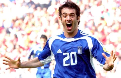 Greece's Georgios Karagounis celebrates after scoring,  during the Euro 2004 Group A soccer match between Portugal and Greece, at the Dragao stadium in Porto, Portugal, Saturday, June 12, 2004. The other teams in Group A are Russia and Spain. (AP Photo/Luca Bruno)
