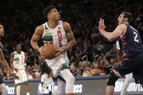 Milwaukee Bucks' Giannis Antetokounmpo, center, drives to the basket during the second half of the NBA basketball game against the New York Knicks, Tuesday, Dec. 25, 2018, in New York. The Bucks defeated the Knicks 109-95. (AP Photo/Seth Wenig)