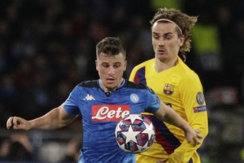 Napoli's Diego Demme, left, and Barcelona's Antoine Griezmann vie for the ball during the Champions League, Round of 16, first-leg soccer match between Napoli and Barcelona, at the San Paolo Stadium in Naples, Italy, Tuesday, Feb. 25, 2020. (AP Photo/Andrew Medichini)