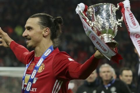 Manchester United's Zlatan Ibrahimovic holds the trophy after Manchester won the English League Cup final soccer match between Manchester United and Southampton FC at Wembley stadium in London, Sunday, Feb. 26, 2017. (AP Photo/Tim Ireland)