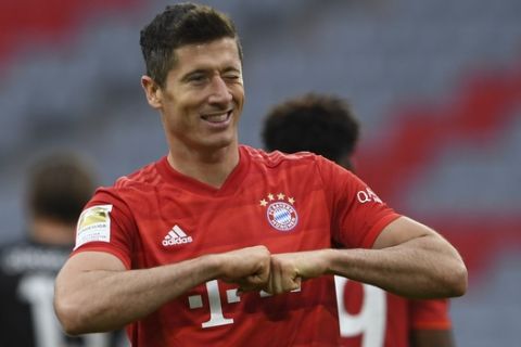 Bayern Munich's Polish forward Robert Lewandowski reacts after scoring his 4-0 during the German Bundesliga soccer match between FC Bayern Munich and Fortuna Duesseldorf in Munich, Germany, Saturday, May 30, 2020. Because of the coronavirus outbreak all soccer matches of the German Bundesliga take place without spectators. (Christof Stache/Pool via AP)